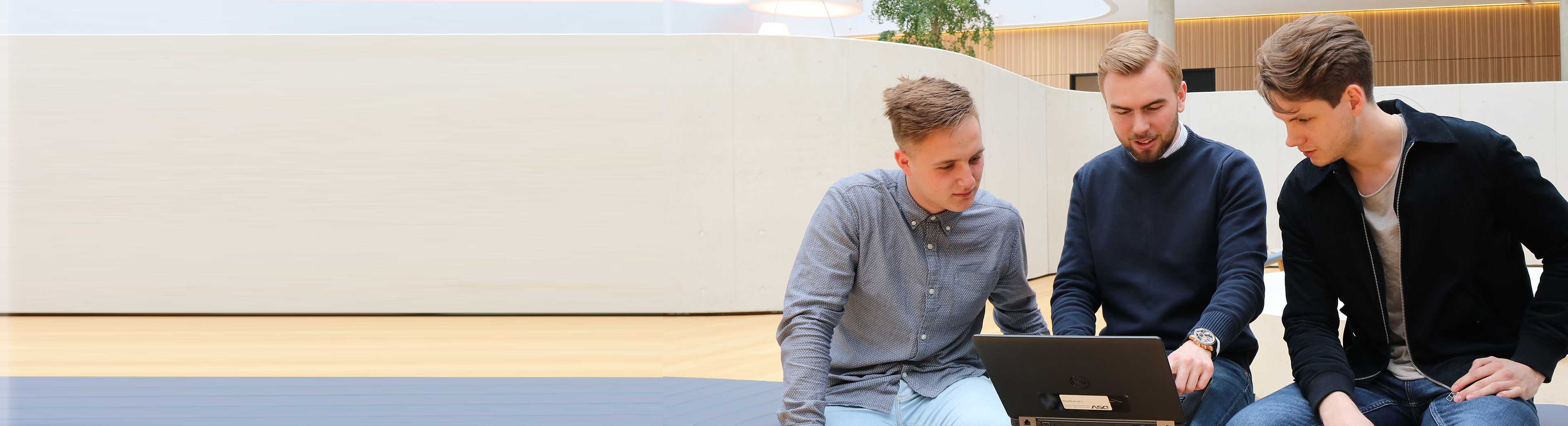 Tree young trainees in a discussion at the DSV headquarter in Hedehusene